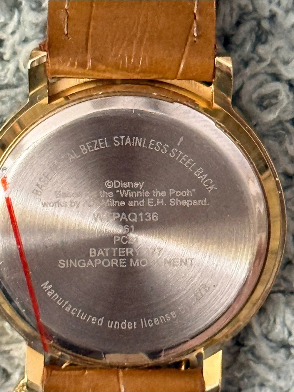 Disney Winnie the Pooh watch features a crystal-bezel dial and dangling charms o
